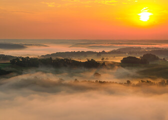sunset in the foggy mountains