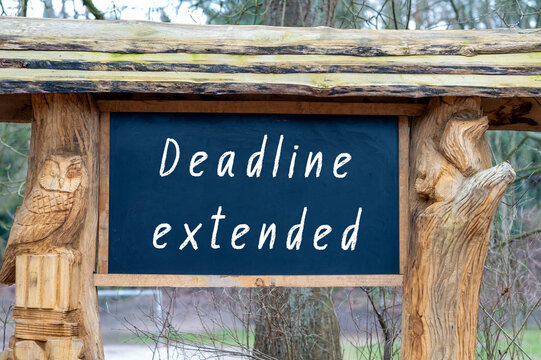 Deadline extended concept with text on table. Business delay, project reschedule, new schedule or time extension announcement. Office desk reminder for planning, due date update, and time management 