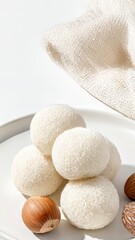 White coconut-covered rice cakes with hazelnuts &ndash; perfect for festive snack visuals and fall celebration &mdash; traditional Korean rice cake dessert perfect for Chuseok, Korean Thanksgiving, Chinese Lunar 