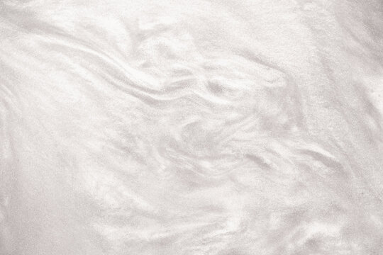 Shimmering silver abstract background. Liquid glitter paint texture waves and swirls. Beautiful shiny white glitter texture. Metallic silver paint close-up as a holiday background. - Powered by Adobe