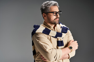 Stylish man showcases elegance in a trendy outfit during studio fashion shoot
