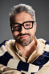Fototapeta premium Stylish man in elegant outfit poses confidently in a modern studio environment
