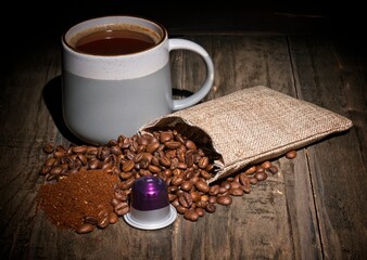 Coffee cup with roasted beans and coffee capsule