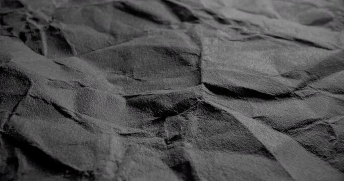 Abstract Dark Wrinkled Surface Moving. smooth movement across a dark textured surface with visible creases and grain.