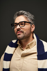 Obraz premium Stylish man showcases elegance and modern fashion in a studio setting