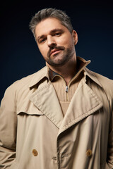 Stylish man with bristle posing confidently in trendy studio fashion portrait