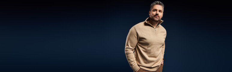 Stylish man in a trendy outfit poses in a chic studio during a fashion shoot