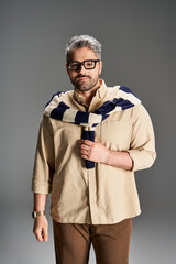 Handsome man showcases stylish elegance in a trendy studio setting