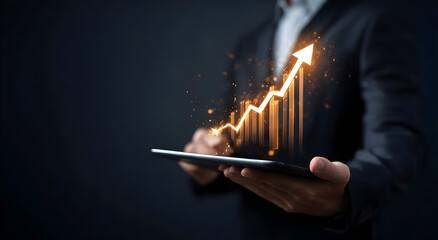 A professional businessman holds a tablet displaying a glowing upward graph, symbolizing growth, success, and digital transformation in the corporate world.
