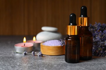 Spa composition with herbal oil and lavender flowers on the table. Beauty treatments. Lavender essential oil still life