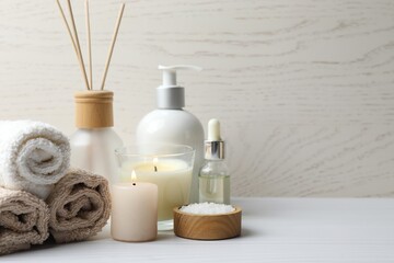 Spa and relax composition with massage oil, towels, candles and aroma diffuser