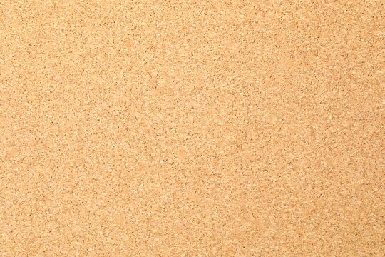 Cork background. Brown yellow color textured cork board background. Natural cork texture. Top view background. High resolution photo. Full depth of field.