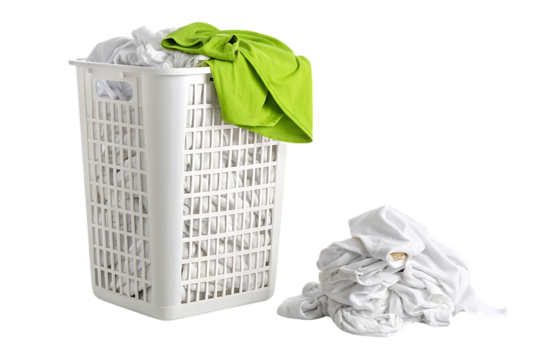 White laundry hamper with lime green shirt draped over side, gray clothes bundled beside the basket, isolated on a transparent background