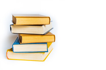 many old vintage tired worn books of yellow, blue, brown colors lie on white background with space...