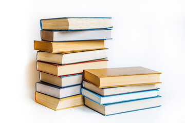 many old vintage tired worn books of yellow, blue, brown colors lie on white background with space...