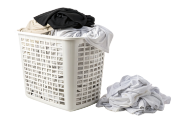White plastic laundry basket filled with mixed clothing items and additional clothes pile beside it, isolated on a transparent background