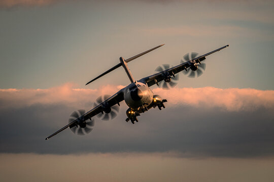 French Air Force Airbus A400M front view in flight at golden hour
