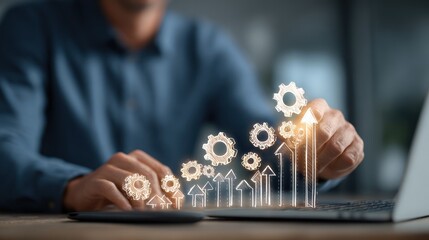A man interacts with a holographic projection of upward-trending graphs and gears displayed on a laptop, symbolizing growth and progress through technological means