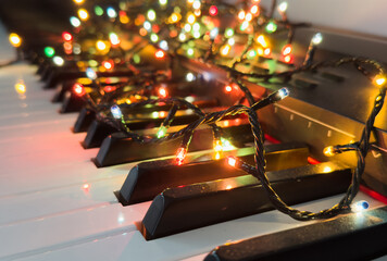 Piano keyboard and Christmas pine tree illuminations. Vibrant colors, Holidays concept
