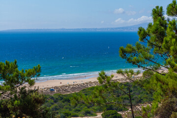A wide, high-angle landscape shot of a sandy beach
