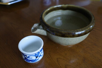 Traditional Japanese Sake Cup and katakuchi on Wooden Table
