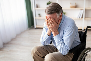 Depression in older adults with disability. Unhappy senior man in wheelchair crying from loneliness at home. Physically impaired male patient suffering from emotional problems