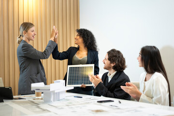 Business people Making High Five after agreement to use solar energy for a residential development...