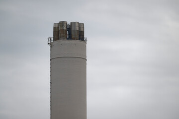Large industrial cylinder structure with tanks and metal pipes at Flensburg Harbor