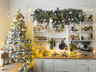 Stylish kitchen with festive decor and Christmas garland. Interior design
