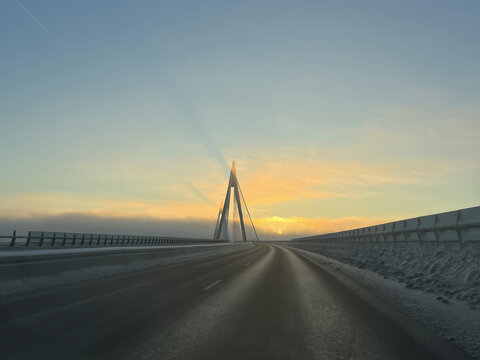 Uddevalla Bridge (Uddevallabron), Sweden. A breathtaking view of the iconic bridge enveloped in a crisp, icy winter morning glow.