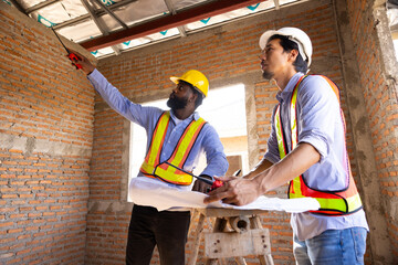 blue print interior design : Architects and contractor working together inside building under...
