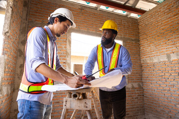 blue print interior design : Architects and contractor working together inside building under...