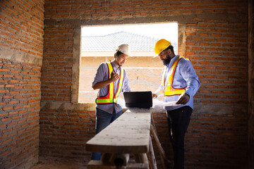 Professional Engineer team Working on Personal Computer at Residential Building Construction site....