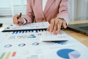 A professional business environment with charts and graphs on a laptop, symbolizing financial analysis, corporate strategy, economic planning, data review, management reporting, growth, consulting, ac