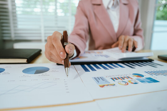 A professional business environment with charts and graphs on a laptop, symbolizing financial analysis, corporate strategy, economic planning, data review, management reporting, growth, consulting, ac