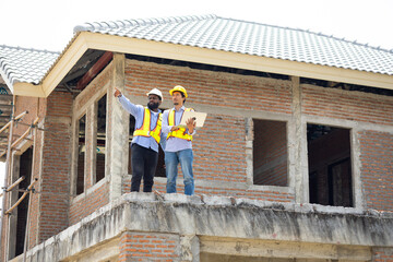 Engineering inspect construction site : construction worker Architects and contractor working together inside building under construction site. Engineering in safety harthat helmet. Engineering team