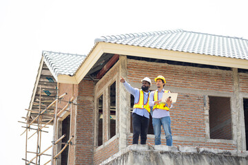 Engineering inspect construction site : construction worker Architects and contractor working together inside building under construction site. Engineering in safety harthat helmet. Engineering team
