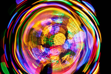 Fantastic abstract dynamic background of neon glow circle lines on dark background. Colorful spots...