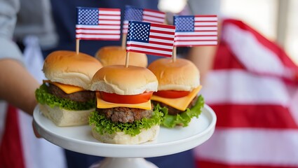 Delicious mini burgers topped with american flags on a white platter