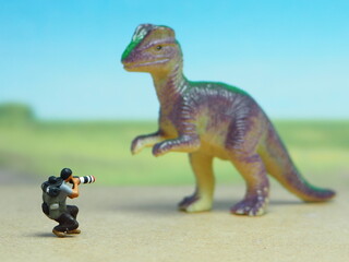 Mini toy of action figure at table with blurred background. Miniature photography concept design....