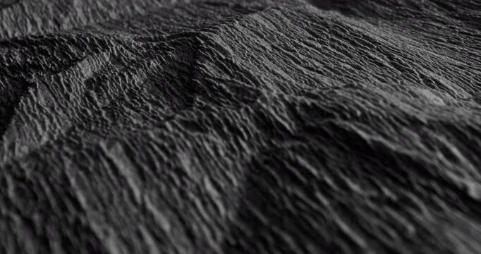 Black Crumpled Texture with Linear Motion. Video showing dynamic movement over a dark rough texture with crumpled details, suitable for creative projects and abstract design.
