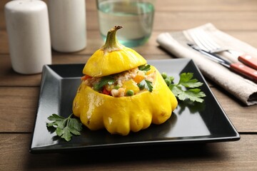Tasty stuffed pattypan squash on wooden table, closeup