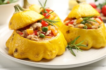 Tasty stuffed pattypan squashes on white wooden table, closeup