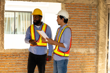 Engineering inspect construction site : construction worker Architects and contractor working together inside building under construction site. Engineering in safety harthat helmet. Engineering team