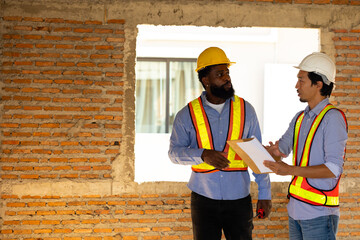 Engineering inspect construction site : construction worker Architects and contractor working together inside building under construction site. Engineering in safety harthat helmet. Engineering team