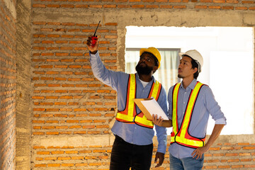 Engineering inspect construction site : construction worker Architects and contractor working together inside building under construction site. Engineering in safety harthat helmet. Engineering team