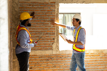 Engineering inspect construction site : construction worker Architects and contractor working together inside building under construction site. Engineering in safety harthat helmet. Engineering team