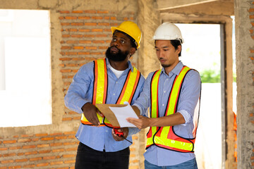 Engineering inspect construction site : construction worker Architects and contractor working together inside building under construction site. Engineering in safety harthat helmet. Engineering team