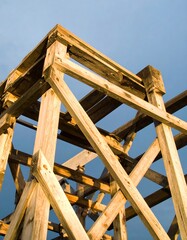 Wooden framework against a pale sky