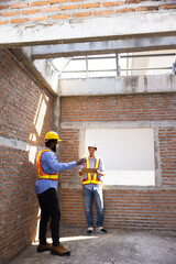interior design : Architects and contractor working together inside building under construction site. home renovation process. Engineering in safety harthat helmet. Engineering team